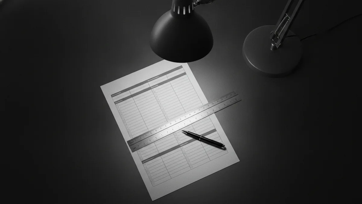 Overhead view of paperwork and tools used to enter loan calculator inputs