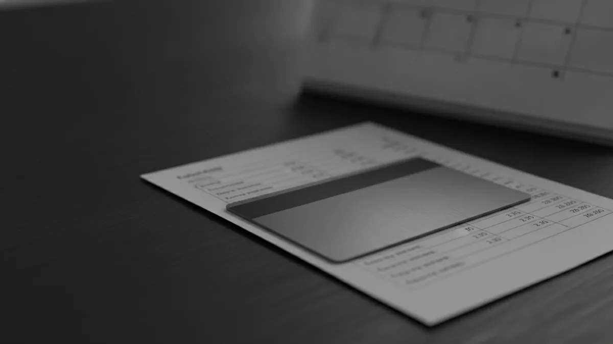 Credit card and statement with a calendar showing an upcoming renewal date.